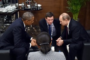 U.S. President Barack Obama, left, speaks with Russian President Vladimir Putin, right, prior to the opening session of the G-20 summit in Antalya, Turkey, Sunday, Nov. 15 2015.