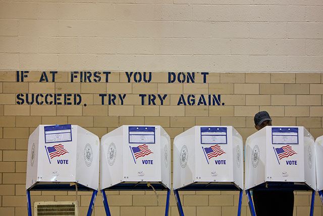 Eustace Moitt checks voting booths for supplies at a polling station in New York, on June 26, 2012. (Todd Heisler / The New York Times)