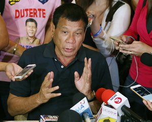 Front-running Presidential candidate Rodrigo Duterte answers questions from the media following his meeting with some politicians who shifted political support to his camp Friday, April 29, 2016 in Manila, Philippines. Duterte is facing another controversy after allegedly failing to declare his P211 million Pesos ($4.5 million US Dollars) 2014 bank deposits as required by law. (AP Photo/Bullit Marquez)