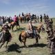 Lakota riders from the Rosebud, Standing Rock and Lower Brule Reservations stood against a police line in a peaceful demonstration this month as part of a traditional ceremony to introduce horses. Credit Daniella Zalcman