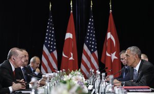 U.S. President Barack Obama, right, and Turkish President Recep Tayyip Erdogan look to each other as Obama talks to media after a bilateral meeting in Hangzhou in eastern China's Zhejiang province, Sunday, Sept. 4, 2016, alongside the G20.