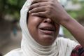 Salema Khatu reacts after seeing a photograph of her son, Habil, who died in an area for Muslim refugees in north of ...