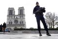 A French police officer stands guard outside Notre Dame cathedral in Paris earlier this year.