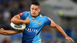 GOLD COAST, AUSTRALIA - AUGUST 27: Jarryd Hayne of the Titans has the ball stripped from him by Tyrone Peachey of the ...