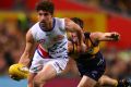 On the run: Tom Liberatore looks to offload the ball for the Bulldogs. 
