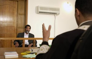 File - Former and deposed President of Iraq, Saddam Hussein, sits before an Iraqi judge at a courthouse in Baghdad, Iraq, 1 July, 2004. He was subsequently sentenced to death by hanging.