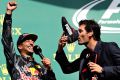 Sparkling success: Mark Webber drinks champagne from Daniel Ricciardo's racing shoe after the Australian driver's ...