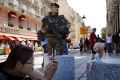 A French soldier stands guard as a tourist takes pictures of her doll in front of Notre Dame cathedral in Paris on Friday.