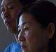 In-Young Joyce (right) with her husband Myung Jin Juong (left) at their home in Epping. Both In-Young and Myung suffered ...