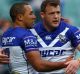 Moses Mbye of the Bulldogs celebrates scoring a try with Bulldogs teammate Josh Morris.