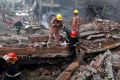 Rescue personnel work at the site of the factory fire. 