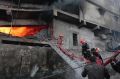 Firefighters work to put out the fire at a packaging factory in Tongi industy area outside Dhaka, Bangladesh.