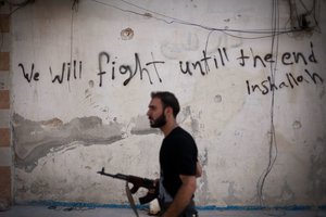 In this Sept. 10, 2012 file photo, a Free Syrian Army fighter walks through a street in the Amariya district in Aleppo, Syria.