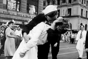 V-J Day in Times Square, a photograph by Alfred Eisenstaedt, was published in Life in 1945 with the caption, "In New York's Times Square a white-clad girl clutches her purse and skirt as an uninhibited sailor plants his lips squarely on hers" - Edith Shain