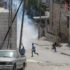 Children running away from tear gas shot by Israeli Forces at Salaymeh checkpoint