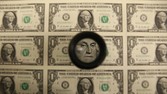 WASHINGTON, DC - MARCH 24: A magnifying glass is used to inspect newly printed one dollar bills at the Bureau of Engraving and Printing on March 24, 2015 in Washington, DC. The roots of The Bureau of Engraving and Printing can be traced back to 1862, when a single room was used in the basement of the main Treasury building before moving to its current location on 14th Street in 1864. The Washington printing facility has been responsible for printing all of the paper Federal Reserve notes up until 1991 when it shared the printing responsibilities with a new western facility that opened in Fort Worth, Texas. (Photo by Mark Wilson/Getty Images)