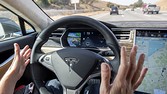 A member of the media test drives a Tesla Motors Inc. Model S car equipped with Autopilot in Palo Alto, California, U.S., on Wednesday, Oct. 14, 2015. Tesla Motors Inc. will begin rolling out the first version of its highly anticipated "autopilot" features to owners of its all-electric Model S sedan Thursday. Autopilot is a step toward the vision of autonomous or self-driving cars, and includes features like automatic lane changing and the ability of the Model S to parallel park for you. Photographer: David Paul Morris/Bloomberg