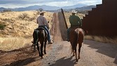 A US border patrol officer liaises with a local rancher at Nogales, Arizona