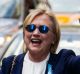 Democratic presidential candidate Hillary Clinton waves as she walks from her daughter's apartment building on September ...