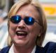 Democratic presidential candidate Hillary Clinton waves as she walks from her daughter's apartment building on September ...