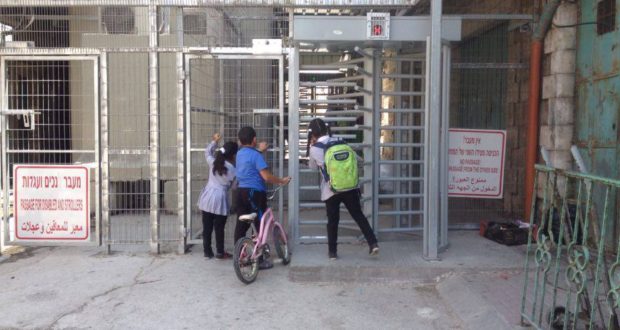 Children forced to persuade soldiers to open the checkpoint-gate at Shuhada checkpoint