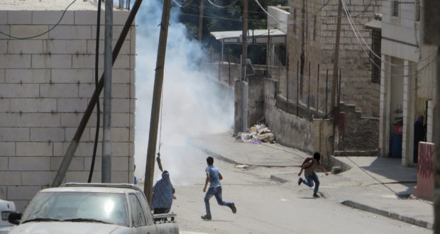 Children running away from tear gas shot by Israeli Forces at Salaymeh checkpoint