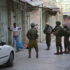 Israeli forces force Palestinian to lift up his shirt during a 'control'