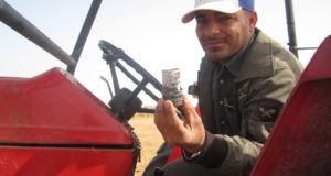 Farmer showing gas canister that was shot by Israeli forces against his tractor