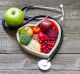 Healthy food in heart and cholesterol diet concept on vintage boards