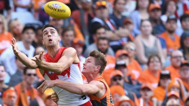 Xavier Richards, of the Swans, marks in front of Adam Tomlinson, of the Giants, during the first  qualifying final ...