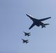 US B-1 bomber, centre, flies over Osan Air Base accompanied by jet fighters.