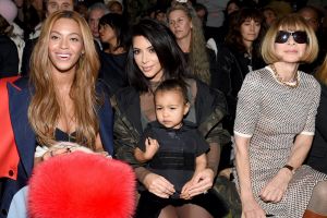 North West wears a Yeezy bullet proof jacket front row with mother Kim Kardashian West, Beyonce and Anna Wintour for ...