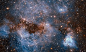 Image captured on Tuesday, 13 September 2016 by the Hubble Space Telescope shows bright-blue wisps of glowing gas and hot, sparkling, young stars within a satellite dwarf galaxy known as the Large Magellanic Cloud (LMC).