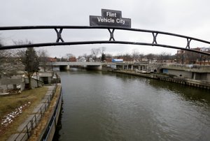 This Jan. 26, 2016, file photo shows a sign over the Flint River in Flint, Mich.