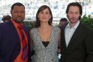 File - American actors, left to right, Laurence Fishburne, Carrie-Anne Moss and Keanu Reeves, pose during the photocall for their film "The Matrix Reloaded" out of competition, directed by American directors the Wachowski brothers at the 56th Film Festival in Cannes, France, Thursday, May 15, 2003.