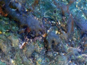 File - This enhanced-color image from March 2012 of a region of Mars near Nili Fossae shows part of the ejecta from an impact crater and contains some of the best exposures of ancient bedrock on Mars. Image was taken by the Mars Reconnaissance Orbiter's HiRISE camera.