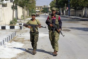 In this Aug. 31, 2016 file photo, Free Syrian Army fighters patrol in Jarablus, Syria.