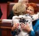 Senator Michaelia Cash hugs Senator Pauline Hanson after her speech in the Senate on Wednesday.