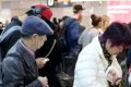 Passengers are seen waiting in long queues as a result of Australian Border Force staff holding a two-hour strike at ...