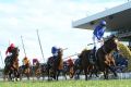 Rise for the Rose: Jockey James McDonald stands up in the irons as he crosses the line to win the Golden Rose on Astern. 