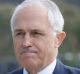 The image of Prime Minister Malcolm Turnbull giving money to a begger in Melbourne on Wednesday has been widely shared.