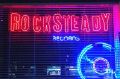 A neon sign beckons music lovers to Rocksteady Records in Melbourne.