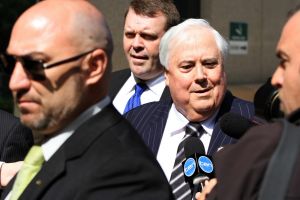 Clive Palmer arrives at the Federal Court on Friday, flanked by private security, for what is expected to be his final ...