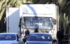 The truck which slammed into revelers late Thursday, July 14, is seen near the site of an attack in the French resort city of Nice, southern France, Friday, July 15, 2016.