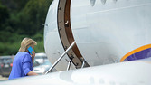 Democratic presidential nominee Hillary Clinton speaks on her mobile phone as she boards her awaiting charter airplane after addressing the National Convention of the American Legion in Cincinnati, Ohio, U.S., August 31, 2016. REUTERS/Bryan Woolston - RTX2NR6E