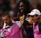 Nic Naitanui is helped from the field in the game against Hawthorn.