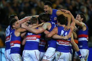 The Western Bulldogs celebrate after dethroning Hawthorn.