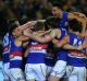 The Western Bulldogs celebrate after dethroning Hawthorn.