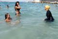 Nesrine Kenza enjoys swimming in her burkini in Marseille, France. The debate over the burkini started in France, where ...