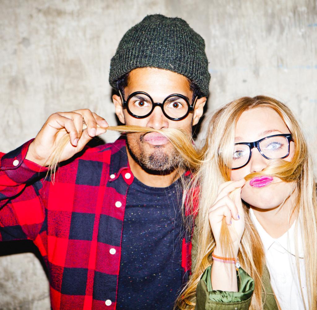 Portrait of two young people pulling funny faces